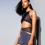 A model wearing a crop top with a geometric cutout in the front